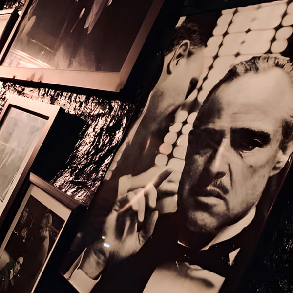 Black and white framed movie posters, including a large one of Marlon Brando as Vito Corleone.